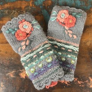 Hand knitted and embroidered wool hand warmers by Lost Horizons.